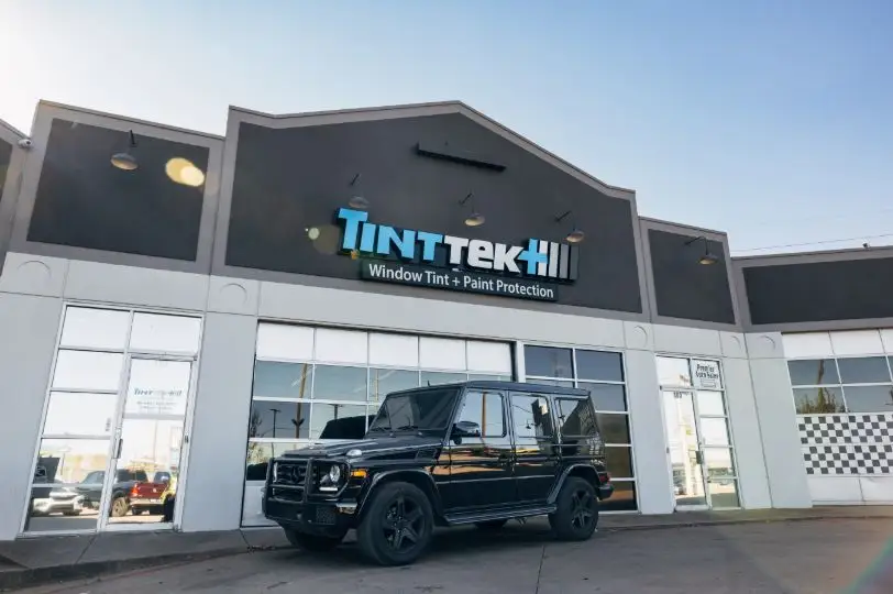Technician performing professional window tint installation near Murphy, TX